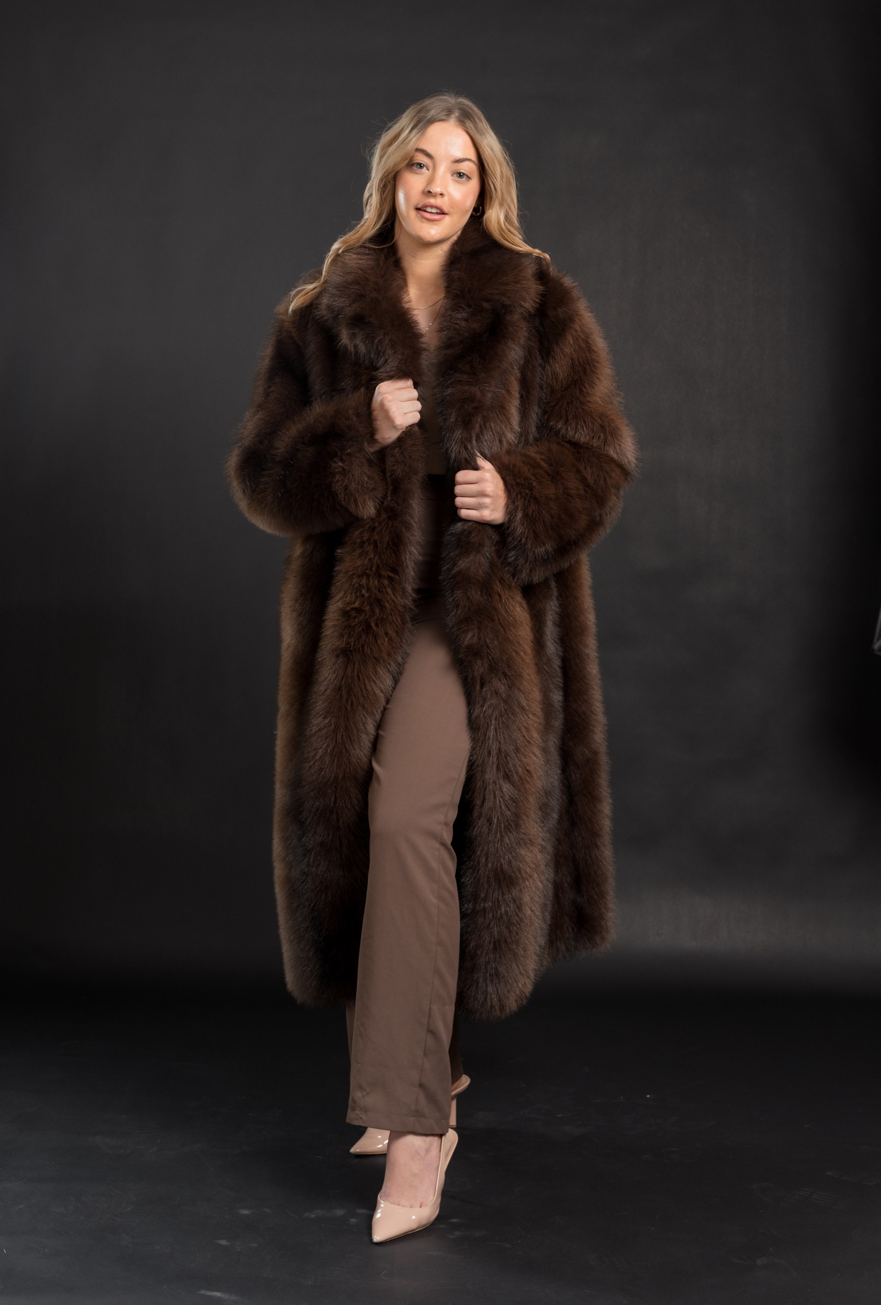Isabella faux fur coat in chocolate brown, full length, worn open over taupe trousers, front view
