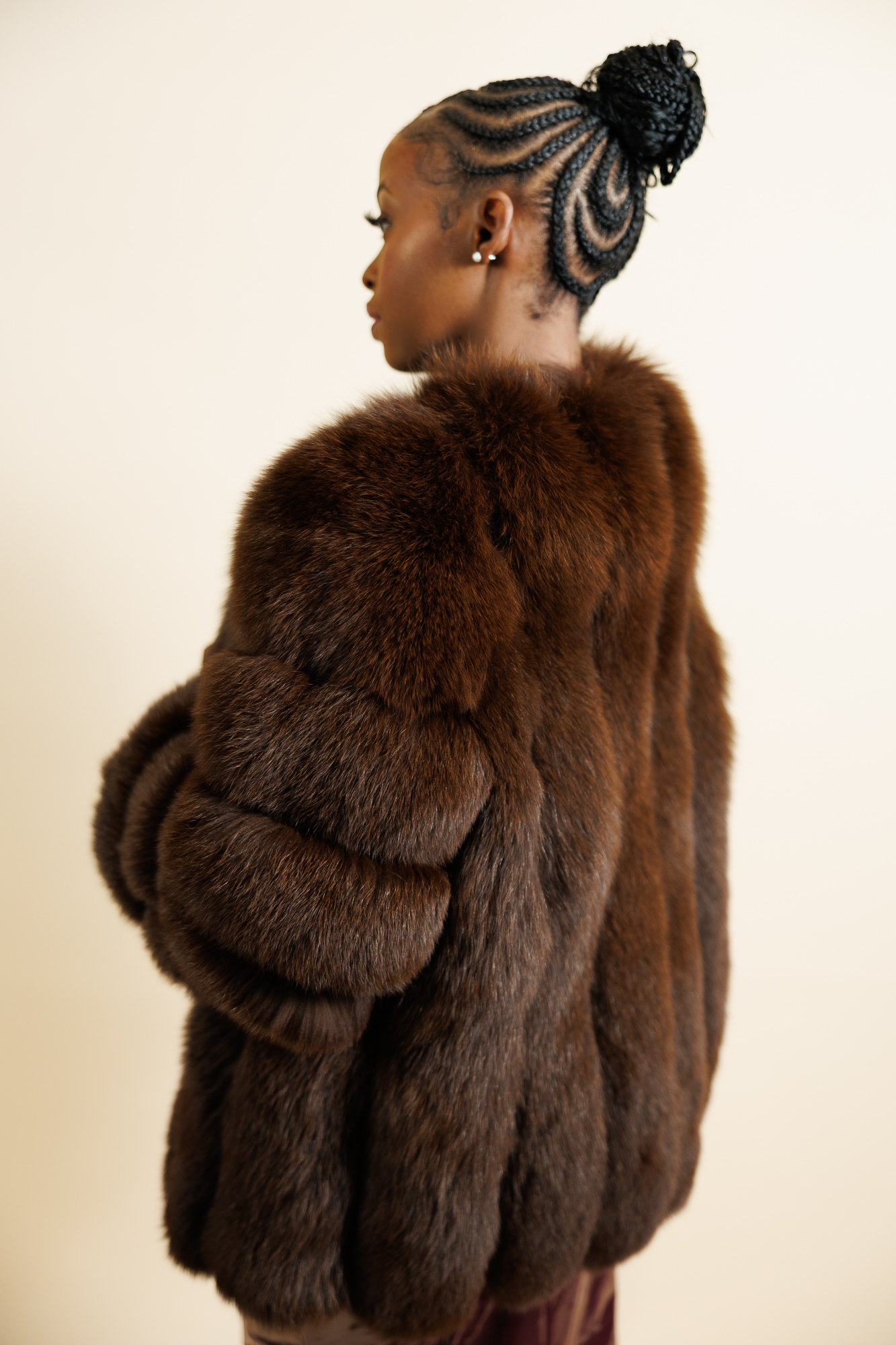 Gstaad fox fur coat in brown, side view showing the horizontal fur panels